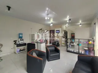 Sala de estar com dois poltronas escuras.