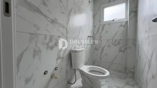 Banheiro com revestimento em mármore branco.