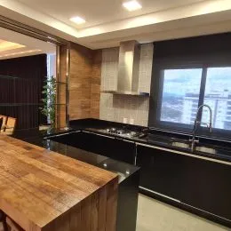 Foto de uma cozinha com bancadas de madeira e vista para a cidade.