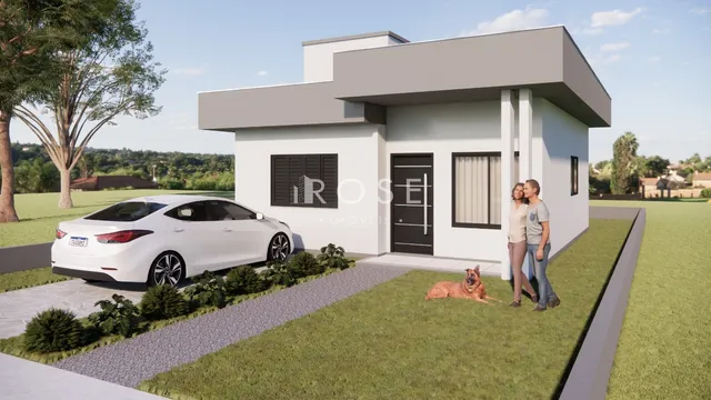 A fachada de uma casa moderna em Lajeado, Brasil, com jardim e carro estacionado.