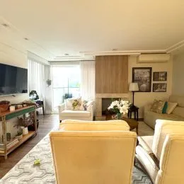 Sala de estar com sofá e iluminação clara em um imóvel.