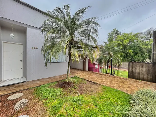 Fachada de uma residência em Lajeado, Brasil com jardim e palmeira.
