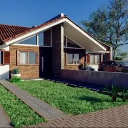 Fachada de uma casa residencial em Lajeado, Brasil, com telhado de telhas vermelhas e jardim frontal.