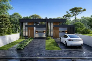 Fachada moderna de uma residência com grandes janelas e paisagismo em Lajeado, Brasil.