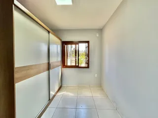 Hall de entrada com piso de cerâmica e porta de correr.
