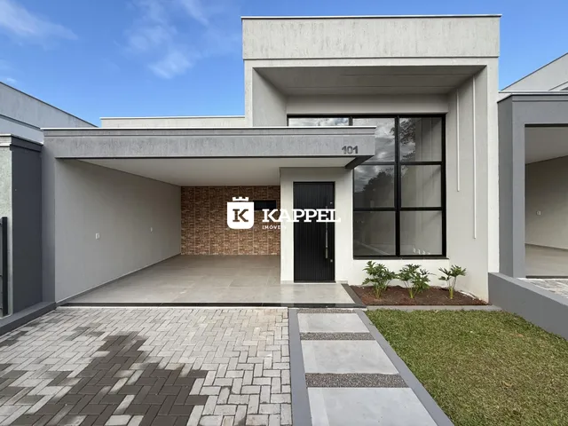 Foto da fachada moderna de uma casa em Lajeado, Brasil, mostrando a entrada e o pátio.