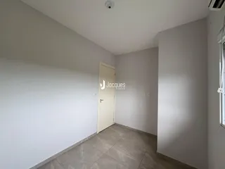 Vista de um corredor interno com porta branca.