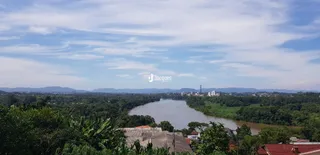 Vista panorâmica de uma paisagem com rio e vegetação.