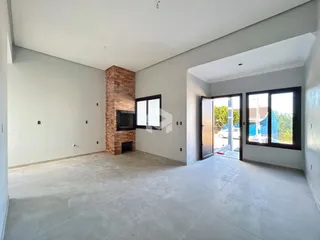 Ambiente interno de uma sala de estar com parede de tijolos expostos.