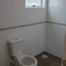 Foto de um vaso sanitário em um ambiente interno com piso cerâmico.