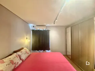 Quarto com cama e armário em ambiente interno.