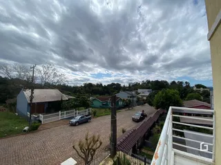 Vista externa de uma propriedade em Lajeado, Brasil, mostrando uma rua pavimentada e casas ao fundo.