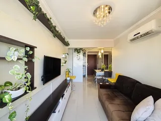 Sala de estar com decoração moderna e luminária de cristal.
