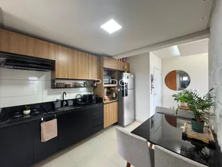 Cozinha moderna com armários de madeira e bancadas escuras.