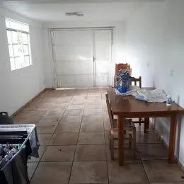Hall de entrada com piso de cerâmica e portas brancas.