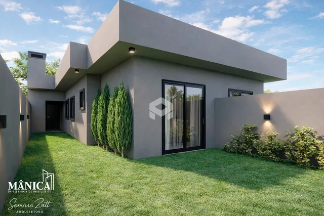 Fachada moderna de uma residência com jardim gramado.