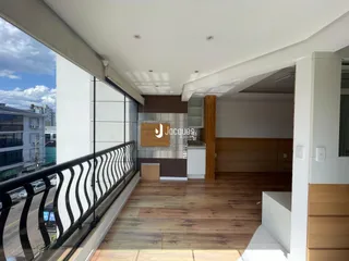 Vista interna de uma sala com piso de madeira e sacada em Lajeado, Brasil.