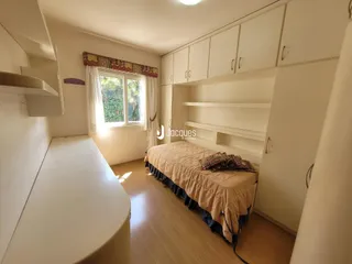 Quarto com armários embutidos e piso de madeira clara.