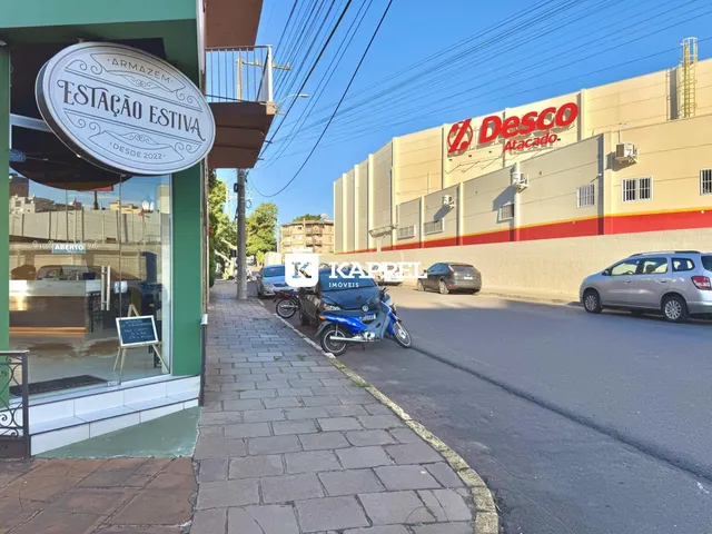 Vista da rua com um prédio comercial e uma loja na Lajeado.