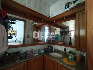 Vista interna de uma sala com detalhes em madeira e bancadas.