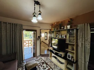 Sala de estar com piso de cerâmica e vista para o exterior.