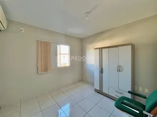 Ambiente interno de uma sala com piso de cerâmica e armário embutido.
