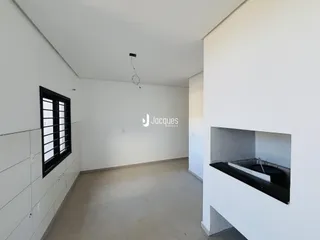 Vista interna de um ambiente com paredes brancas e piso claro.