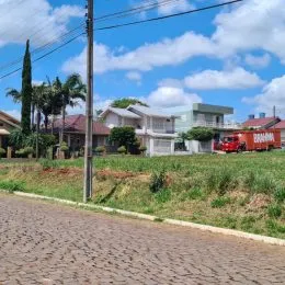 Vista externa de uma residência com vegetação ao fundo.