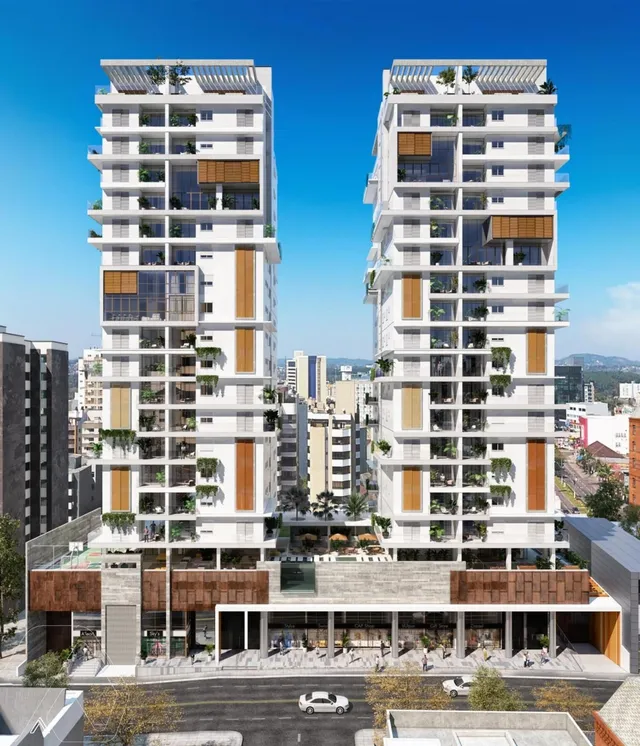 Vista externa de um complexo residencial moderno com dois edifícios altos em Lajeado.