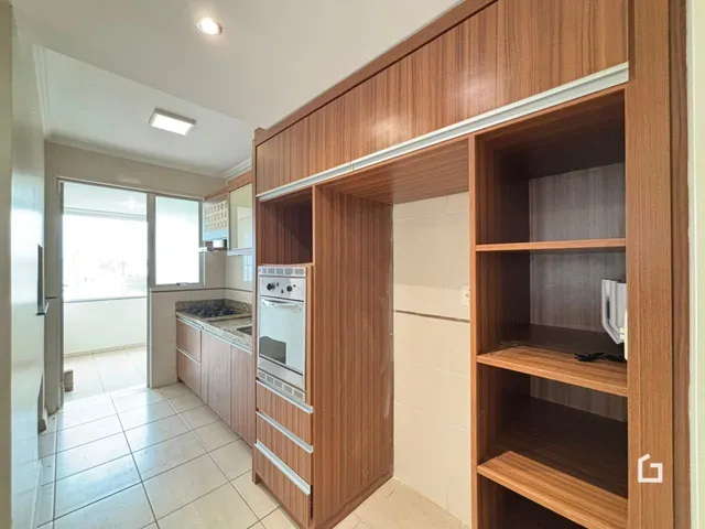 Vista de um corredor com área de cozinha em um imóvel no Brasil.