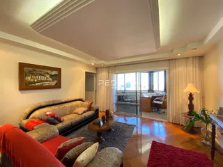 Sala de estar com sofá e piso de madeira em um imóvel no Brasil.