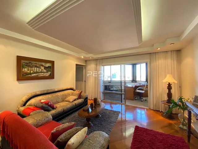 Sala de estar com sofá e piso de madeira em um imóvel no Brasil.