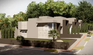 Fachada de uma residência em Lajeado, Brasil, cercada por vegetação.