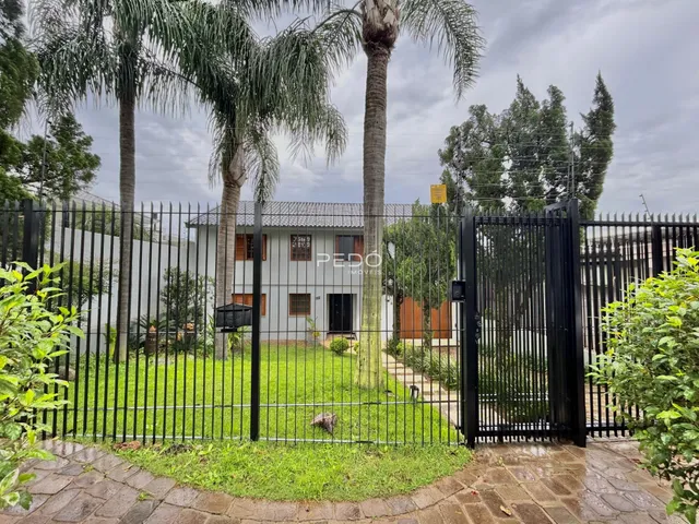 Vista externa de uma propriedade em Lajeado, Brasil, com cerca e jardim.