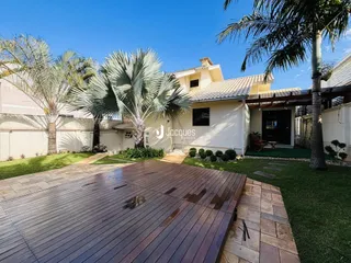 Fachada de uma residência com deck de madeira e jardim em Lajeado, Brasil.