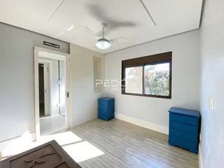 Sala de estar com piso claro e paredes brancas em um imóvel no Brasil.