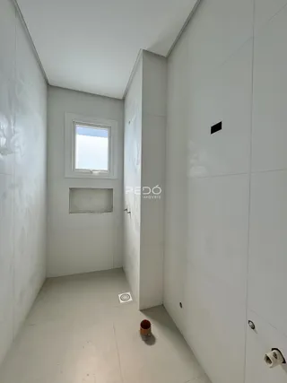 Corredor interno de um imóvel em Lajeado, Brasil, com paredes brancas e piso claro.