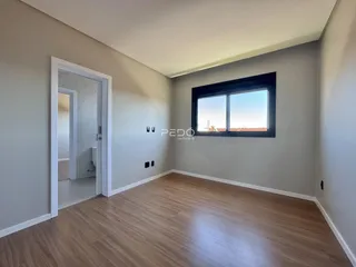 Sala de estar com piso de madeira e janela.