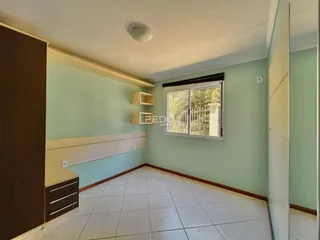 Ambiente interno de uma sala com paredes verde-água e piso de cerâmica.