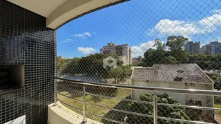 Vista da varanda com vista para a paisagem e edifícios ao fundo.