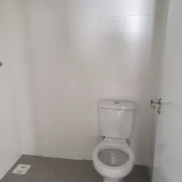 Foto de um vaso sanitário branco em um ambiente interno.