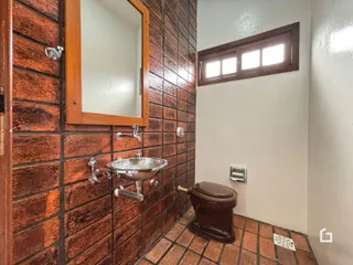 Foto de um banheiro com revestimento de tijolos marrons.
