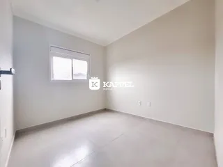 Foto de um cômodo interno com paredes brancas e piso claro.