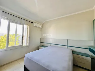 Quarto com janela de grande porte.