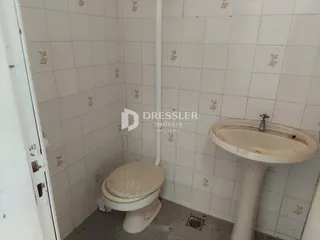 Foto de um banheiro com azulejos brancos.