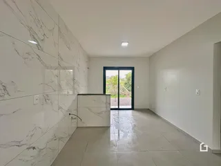 Hall de entrada com revestimento de mármore branco e piso de cerâmica.
