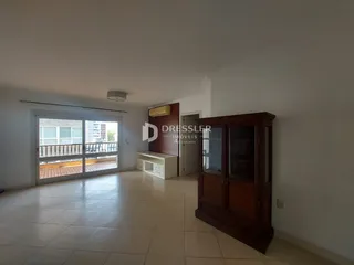 Sala de estar com portas de vidro abrindo para uma varanda.
