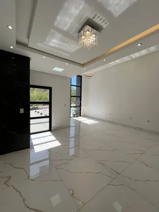 Sala ampla com piso de mármore polido e iluminação clara.