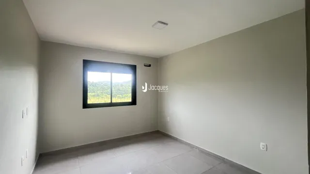 A sala apresenta paredes brancas e um piso claro.