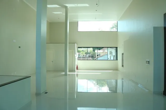 Ambiente interno moderno com piso claro e grande janela.